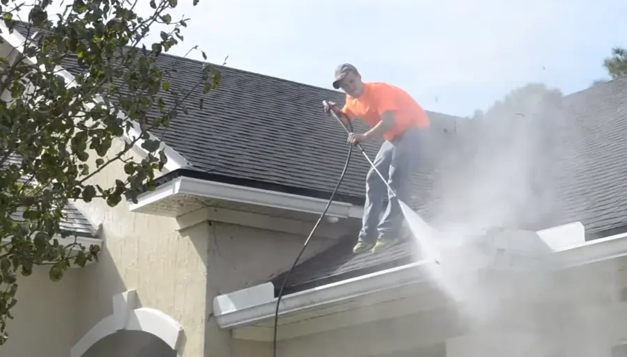 Autumn leaves overflowing a packed gutter before gutter cleaning in Jacksonville FL